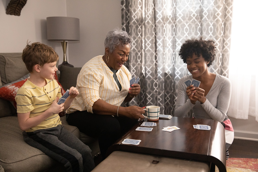 A foster family playing cards together