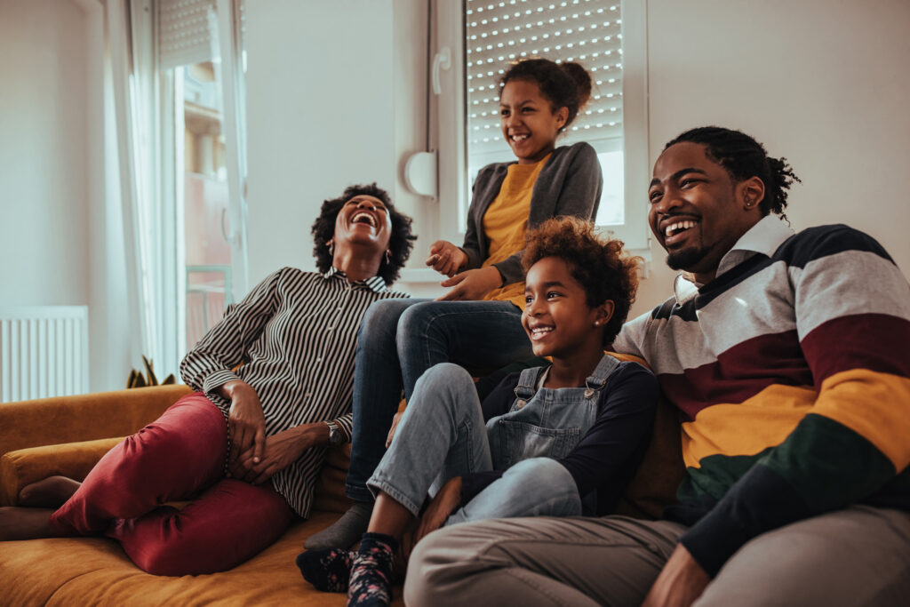 A happy family watching TV together