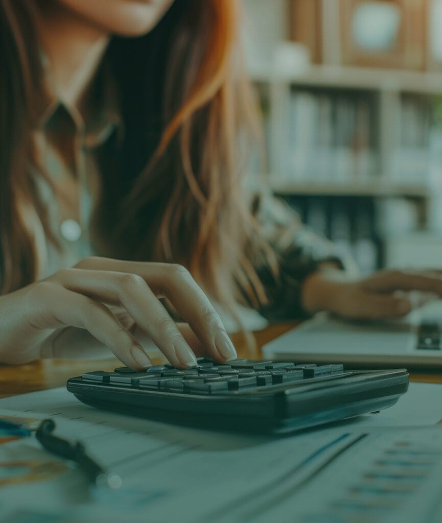 Woman using calculator for fostering support and planning.