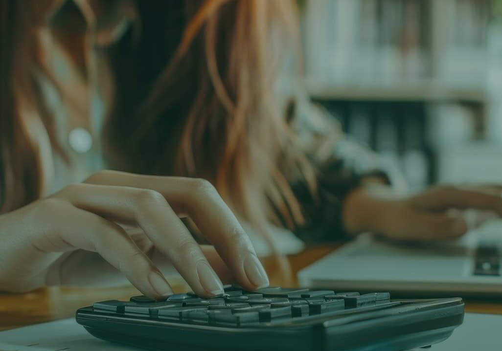 Woman using calculator for fostering support and planning.