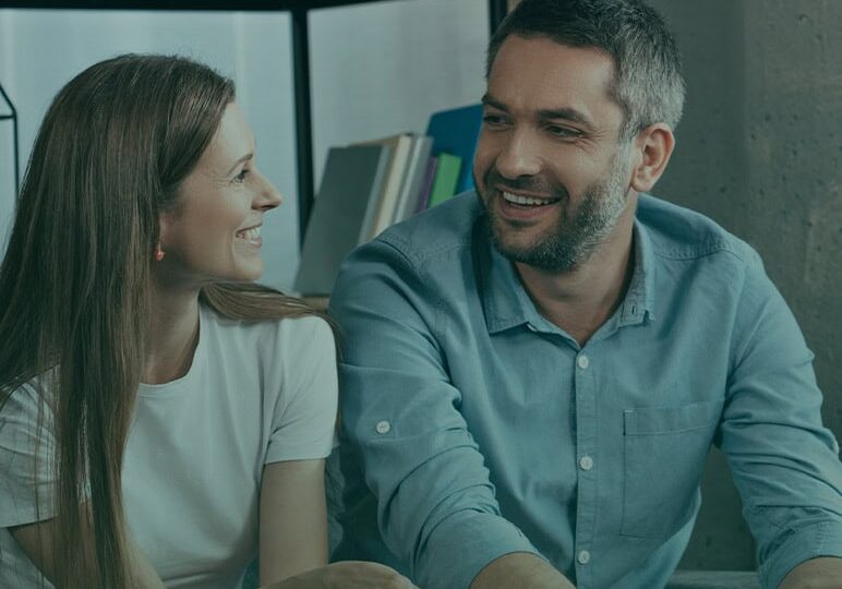 Family counseling session with a smiling therapist and client in a cozy office setting.