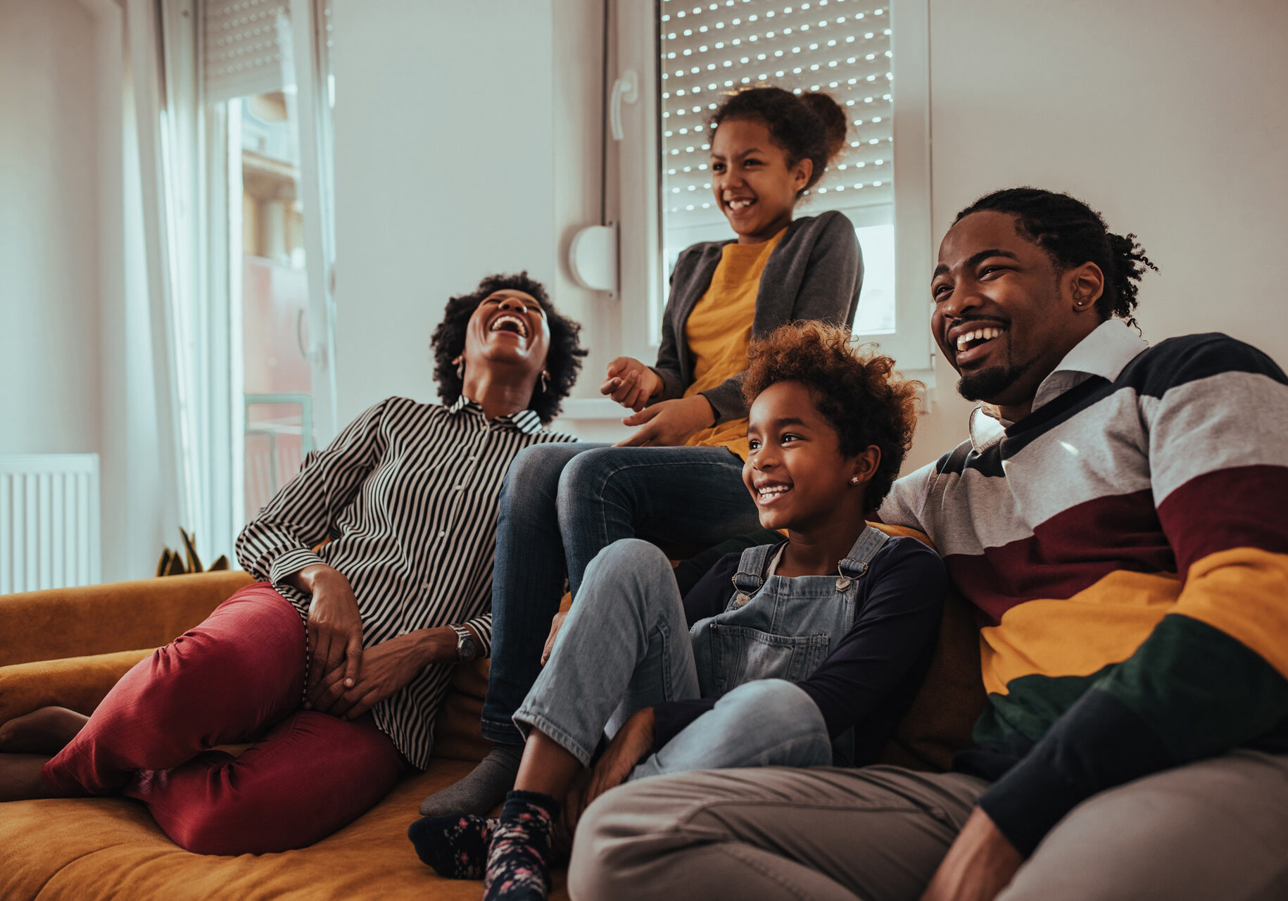 A happy family watching TV together