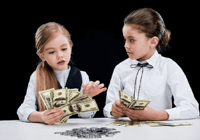 Two young girls counting cash, representing foster care financial support.