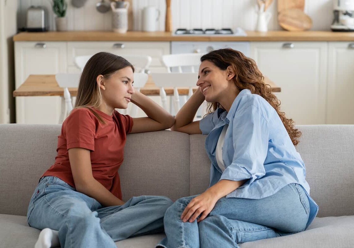 Family counseling session with mother and daughter at home.